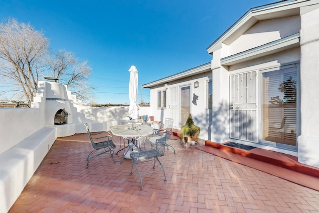 view of patio / terrace featuring exterior fireplace