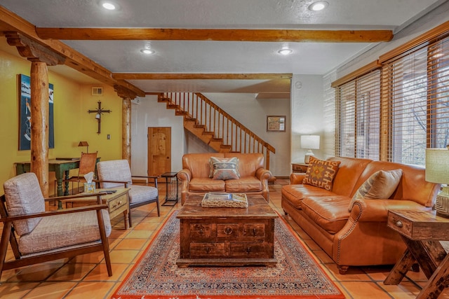 living room with beamed ceiling and light tile patterned floors