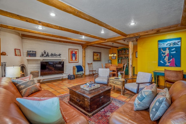 tiled living room with brick wall, beamed ceiling, decorative columns, a large fireplace, and a textured ceiling