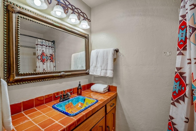 bathroom featuring vanity and a shower with shower curtain