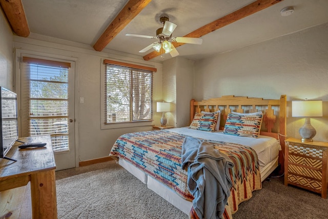 bedroom featuring beam ceiling, carpet, and ceiling fan