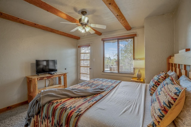 bedroom with beam ceiling, carpet flooring, and ceiling fan