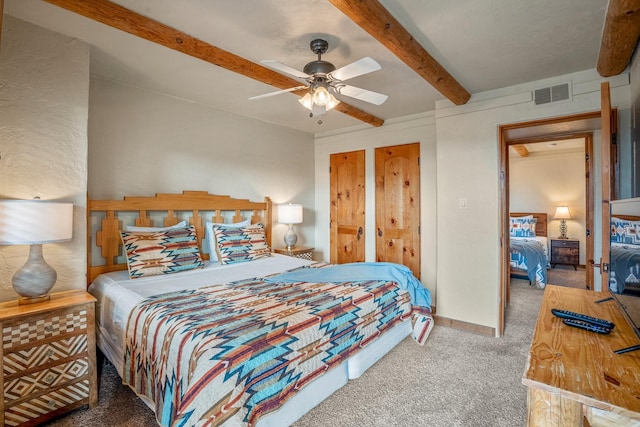 bedroom featuring ceiling fan, carpet flooring, and beam ceiling