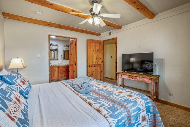 bedroom with beam ceiling, carpet flooring, connected bathroom, and ceiling fan