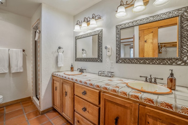 bathroom with vanity, an enclosed shower, and tile patterned floors