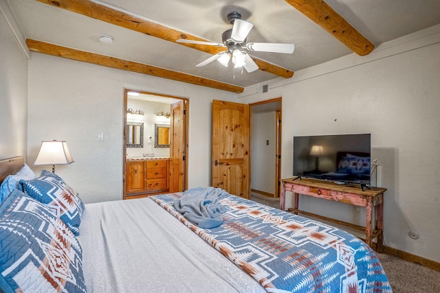 bedroom with ceiling fan, ensuite bathroom, and carpet