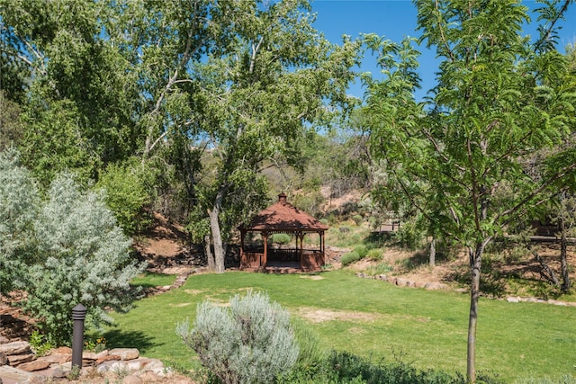 view of property's community with a gazebo and a yard