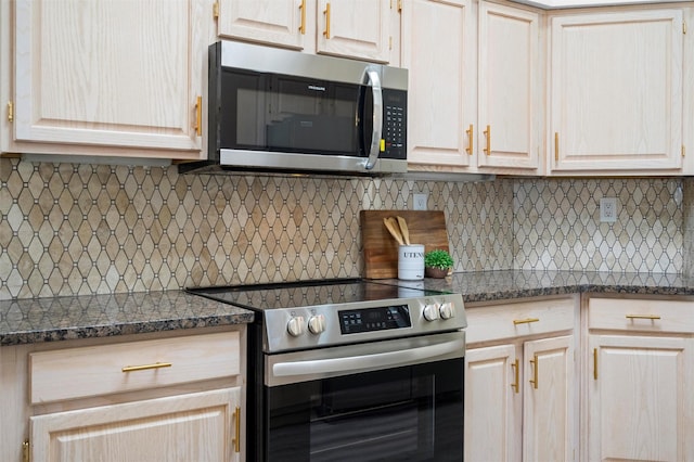 kitchen with tasteful backsplash, dark stone countertops, appliances with stainless steel finishes, and light brown cabinets