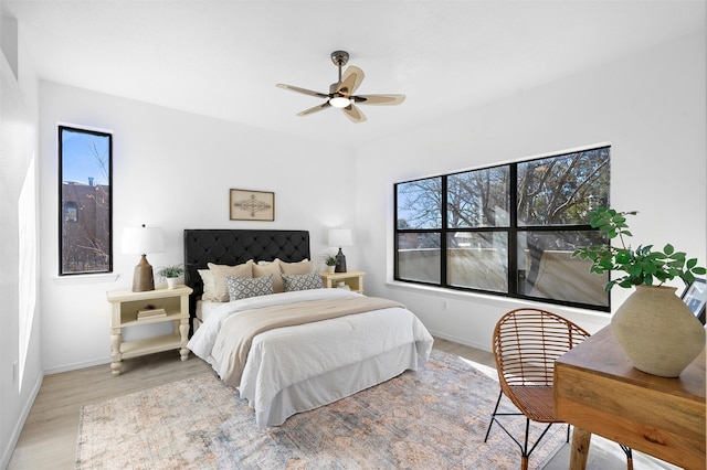 bedroom with ceiling fan and light hardwood / wood-style flooring