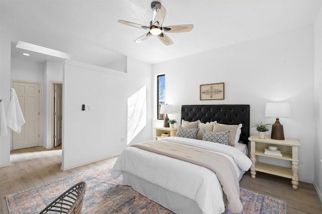 bedroom with ceiling fan and light hardwood / wood-style flooring