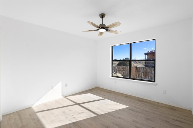 spare room featuring hardwood / wood-style floors and ceiling fan