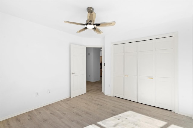 unfurnished bedroom featuring a closet, ceiling fan, and light hardwood / wood-style flooring