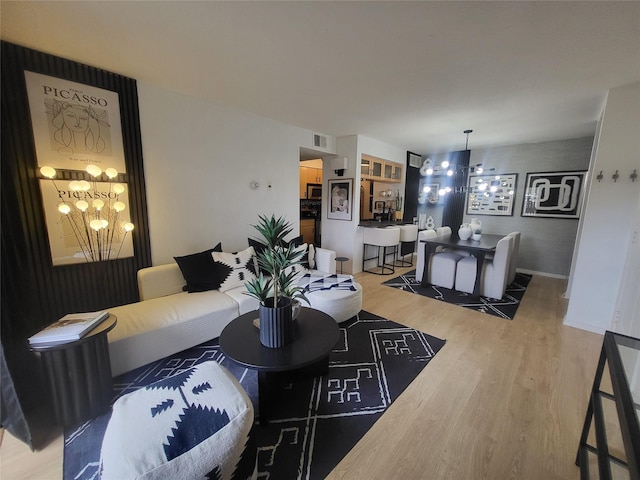 living room featuring hardwood / wood-style floors and a notable chandelier