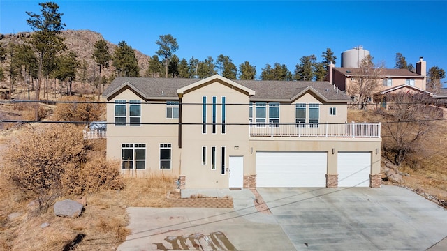 view of front of property featuring a garage and a balcony