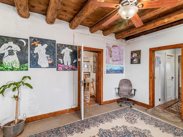 living area featuring ceiling fan, wooden ceiling, and beamed ceiling