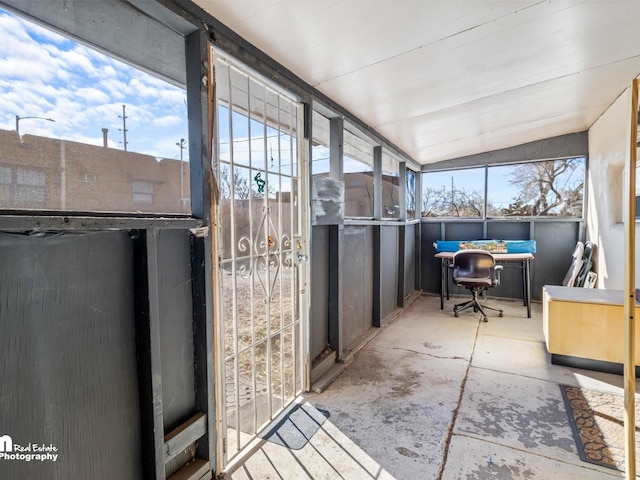 unfurnished sunroom with vaulted ceiling