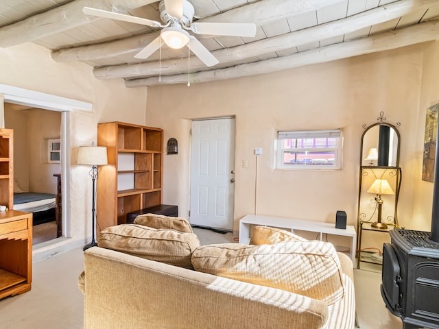 living area with wooden ceiling, a ceiling fan, concrete flooring, and beamed ceiling