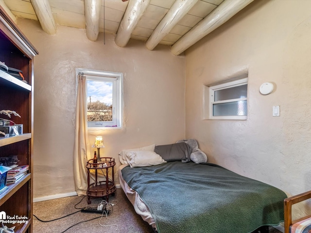 bedroom with beamed ceiling and wooden ceiling