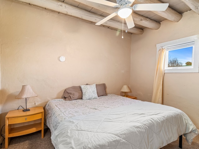 carpeted bedroom with beam ceiling and ceiling fan