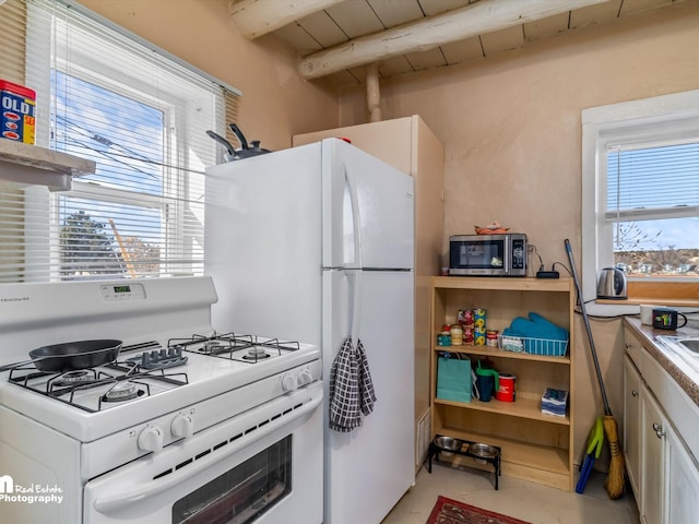 kitchen featuring wood ceiling, white cabinetry, white range with gas cooktop, and beam ceiling