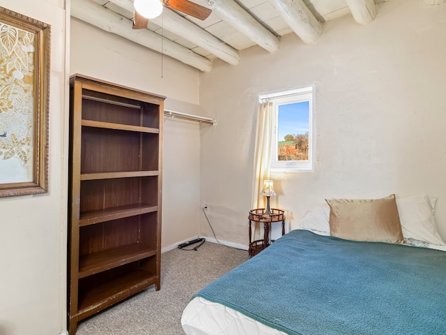 bedroom with carpet flooring and beamed ceiling