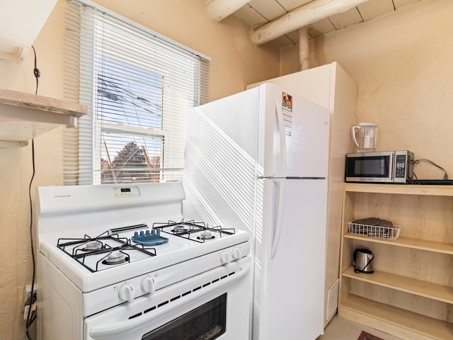 kitchen with stainless steel microwave, white gas range oven, wooden ceiling, and beamed ceiling