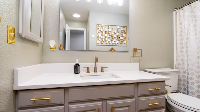 bathroom with vanity, a shower with shower curtain, and toilet