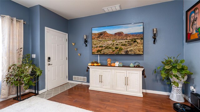 kitchen with sink, white cabinetry, stainless steel appliances, light stone counters, and kitchen peninsula