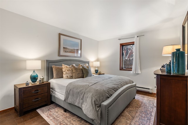 bedroom with dark hardwood / wood-style floors and baseboard heating