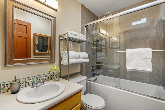 full bathroom with vanity, toilet, and combined bath / shower with glass door