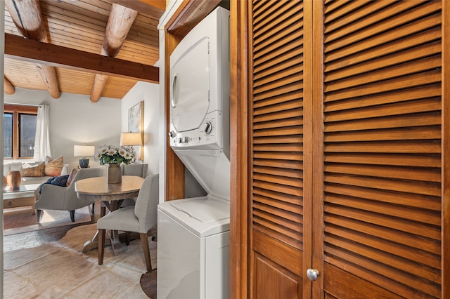 laundry room featuring wood ceiling and stacked washer and dryer