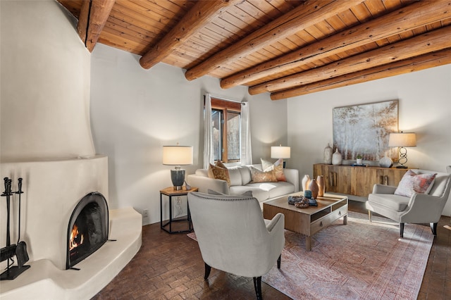 living room featuring wood ceiling, beam ceiling, and a large fireplace