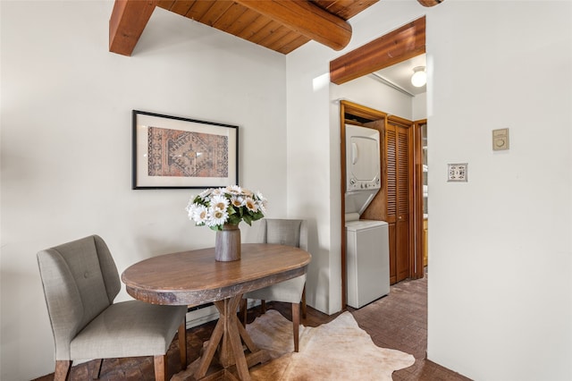 dining room with wood ceiling, stacked washer and dryer, and beam ceiling