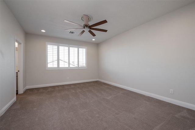 carpeted spare room featuring ceiling fan