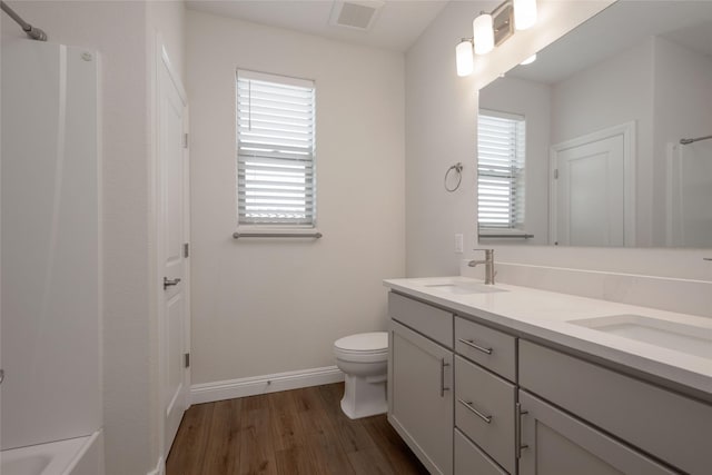 bathroom featuring wood-type flooring, toilet, and vanity