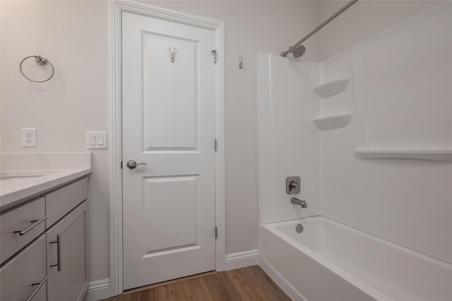 bathroom with vanity, hardwood / wood-style floors, and shower / bathtub combination