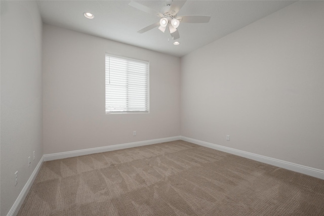 carpeted empty room featuring ceiling fan