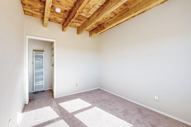 unfurnished room featuring light colored carpet, wooden ceiling, and beam ceiling