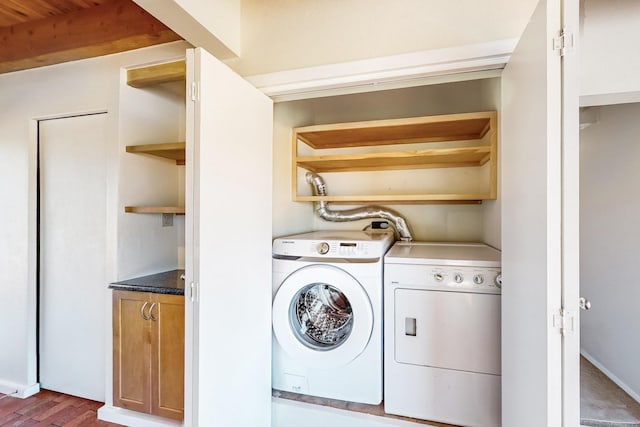 clothes washing area featuring wood-type flooring and washing machine and dryer