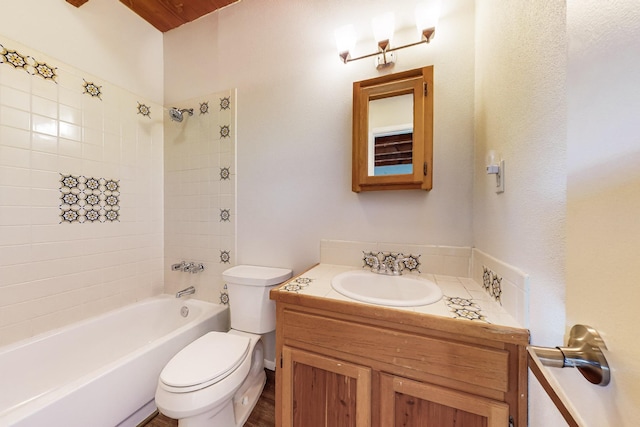 full bathroom with vanity, tiled shower / bath combo, and toilet