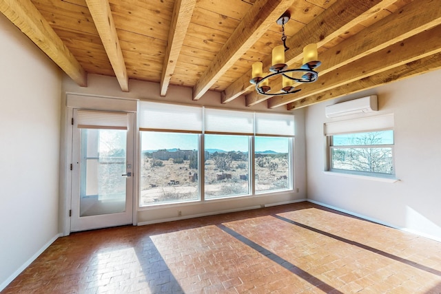 unfurnished sunroom featuring beamed ceiling, a wall mounted AC, wood ceiling, plenty of natural light, and an inviting chandelier