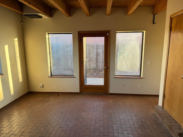 unfurnished room featuring beam ceiling and wooden ceiling