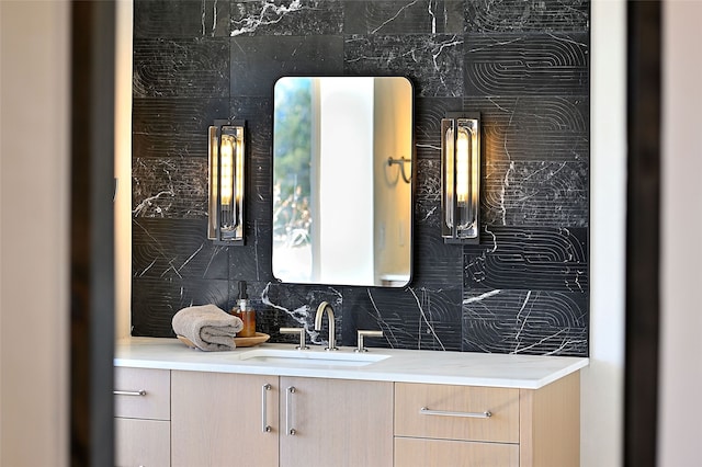 bathroom featuring vanity and decorative backsplash