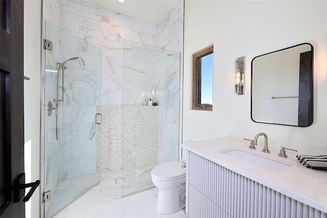 bathroom with toilet, vanity, and a shower with shower door