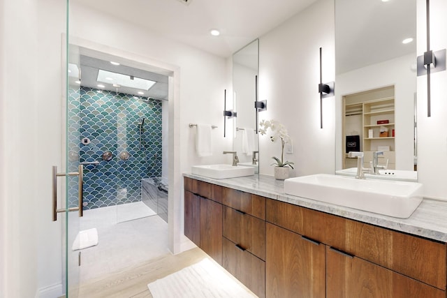 bathroom featuring vanity and a shower with door