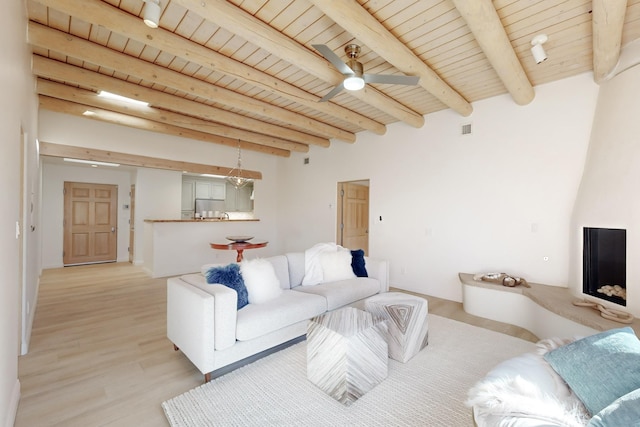 living room with wood ceiling, ceiling fan, beam ceiling, and light wood-type flooring