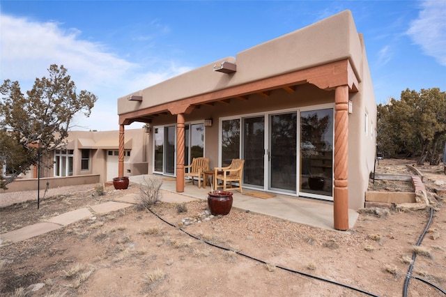 back of property featuring a patio