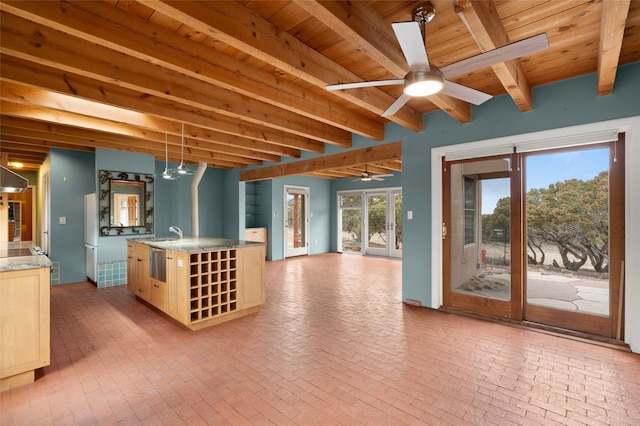 interior space featuring ceiling fan, beam ceiling, sink, and wooden ceiling