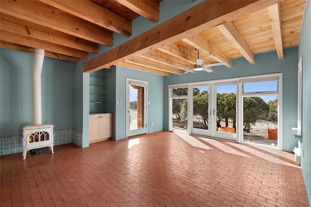 interior space with wooden ceiling, french doors, beamed ceiling, and a wood stove