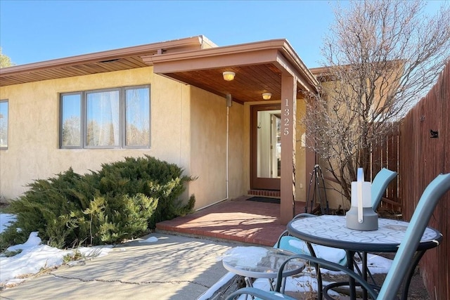 entrance to property featuring a patio area